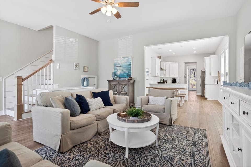 Bright, beach‑inspired lounge with soft neutrals and ocean‑blue accents.
