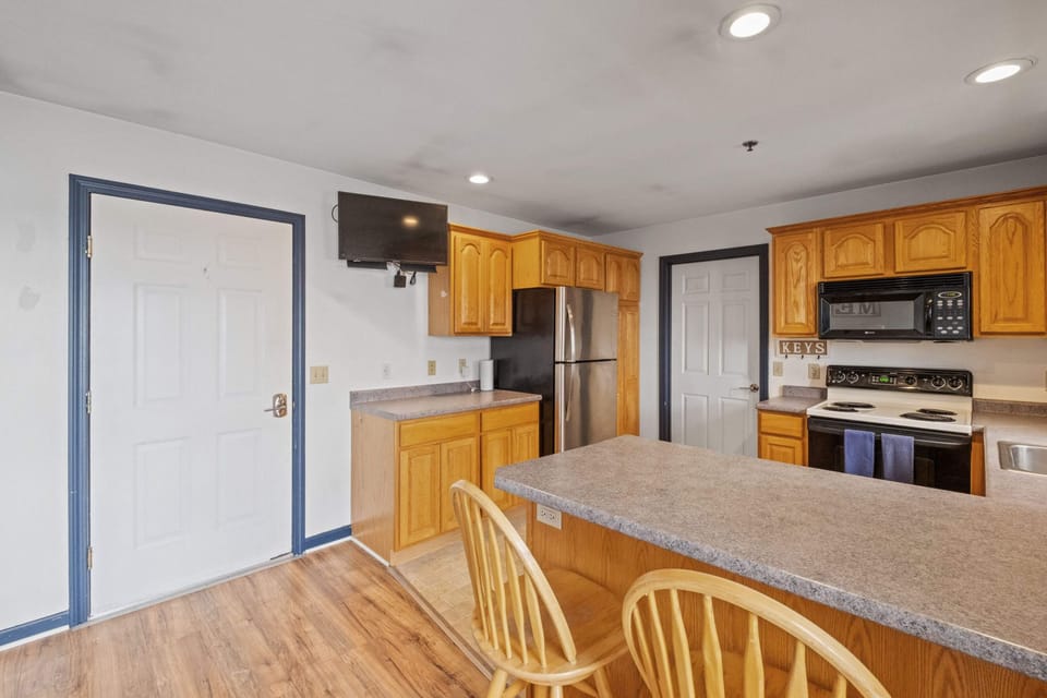 Full kitchen with breakfast bar provides plenty of space for cooking and eating.