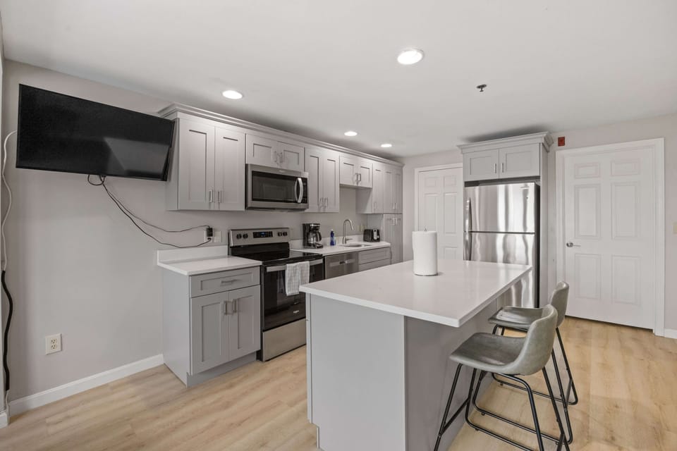 Full kitchen with island provides plenty of space for cooking and eating.