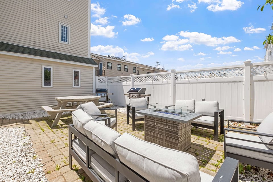 Large outdoor courtyard with shared propane grills and fireplace.
