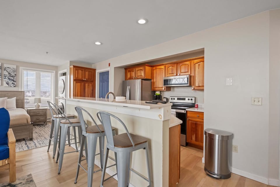 Full kitchen with breakfast bar provides plenty of space for cooking and eating.