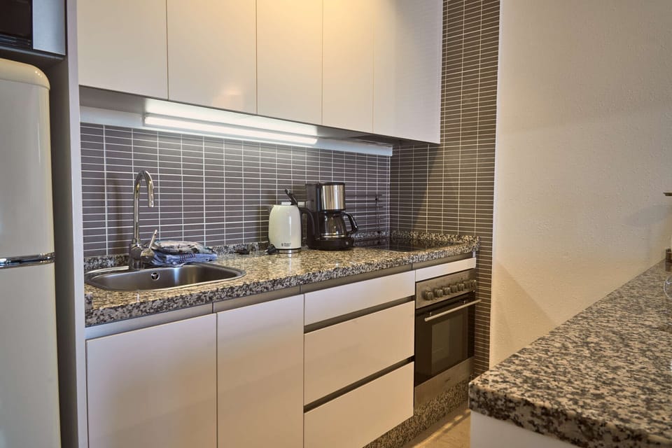Microwave, dishwasher, coffee/tea maker, cookware/dishes/utensils