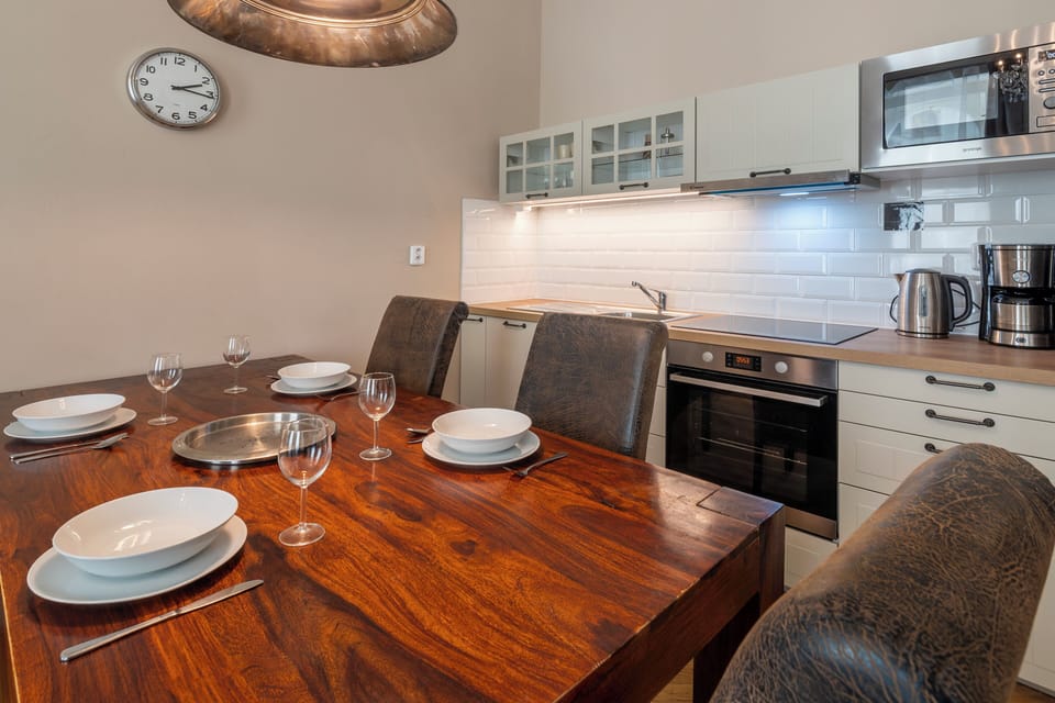 Large dining table and kitchenette in living room