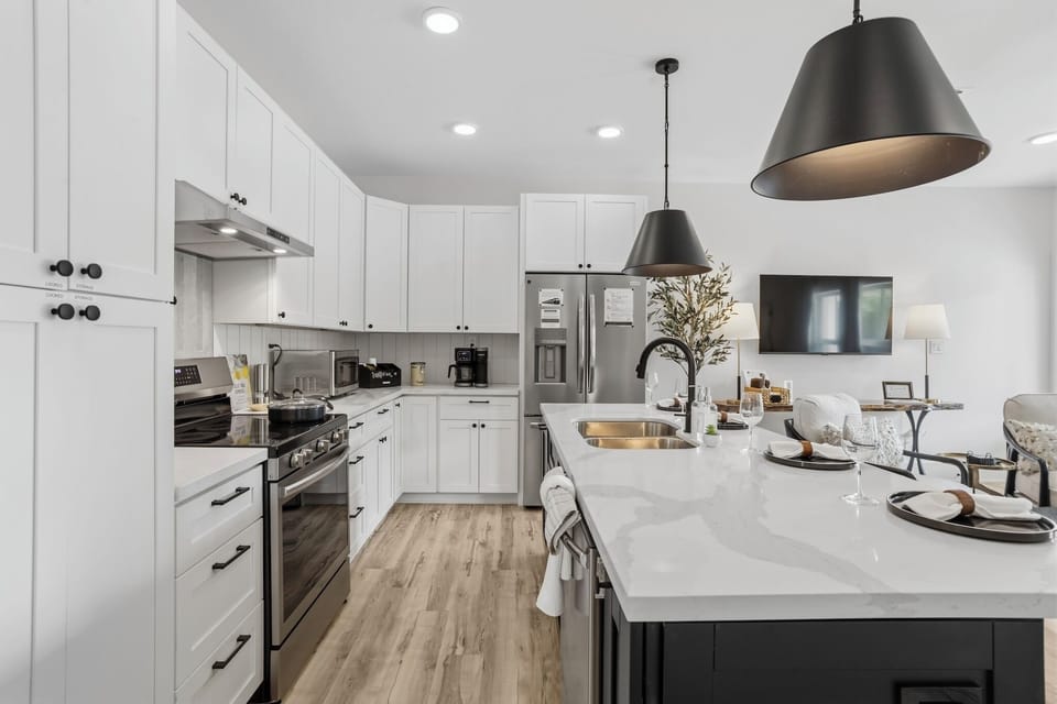Whip up delicious meals in this stylish kitchen with quartz counters and modern appliances!