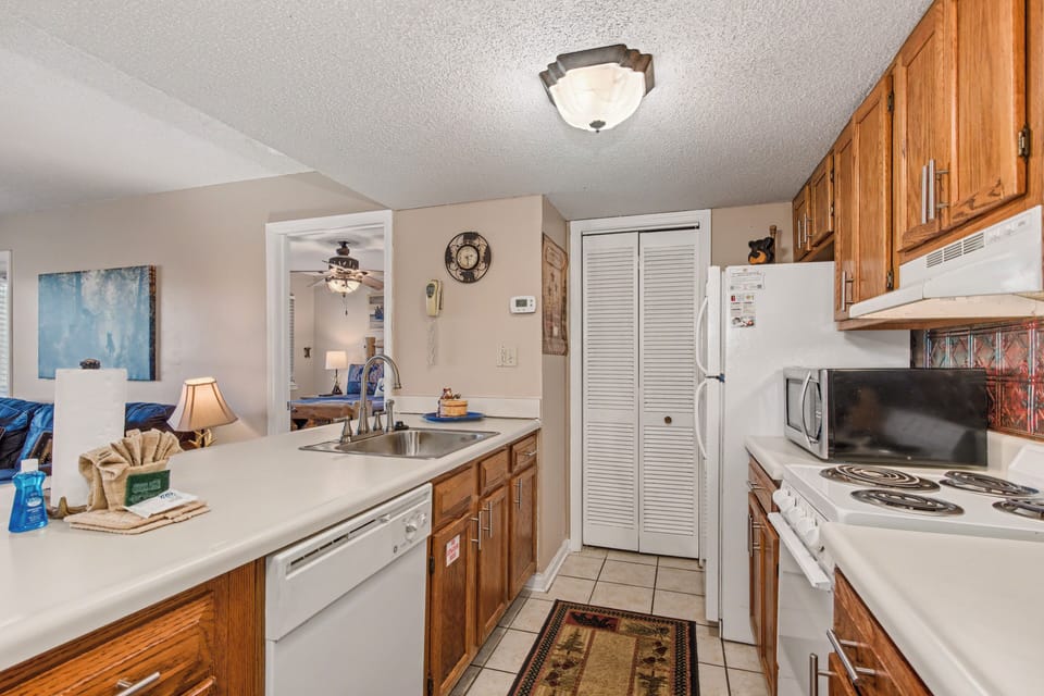 Cook your favorite meals in this fully-equipped kitchen with warm wood cabinets, modern appliances, and plenty of counter space for prep.