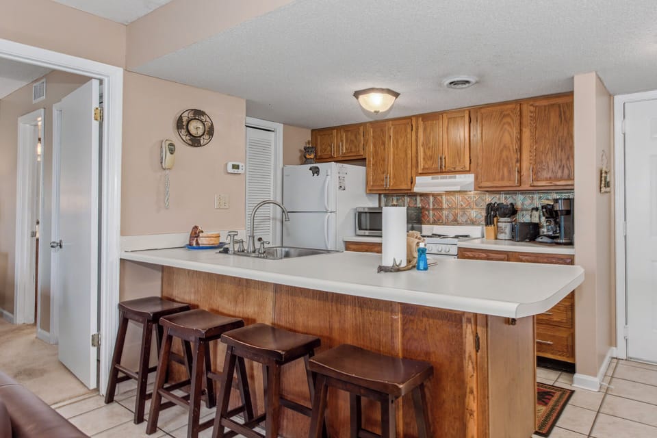 Your fully equipped kitchen with breakfast bar seating invites you to prepare meals and gather with loved ones in this warm, welcoming space.
