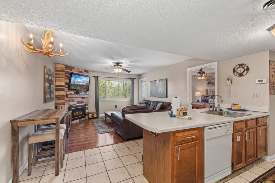 Relax in your open-concept mountain retreat with rustic charm, cozy fireplace, and modern kitchen perfect for cooking together.