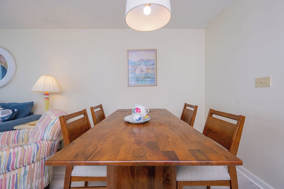 Gather around the inviting dining table, sharing laughter and stories as the beach vibes surround you