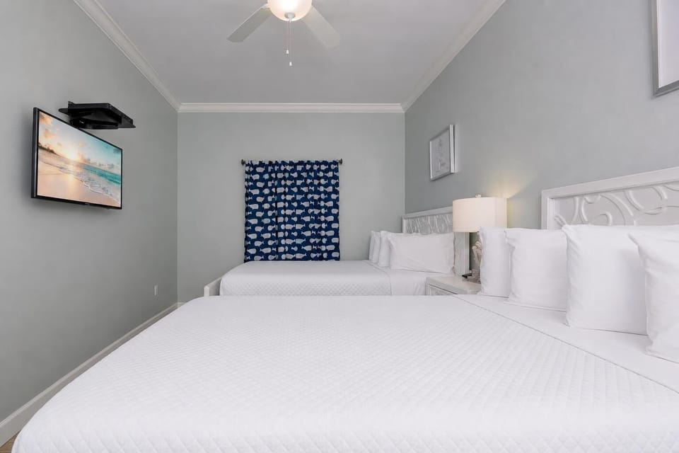 This guest suite with two queens welcomes you to rest deeply after a day full of family fun and coastal adventures