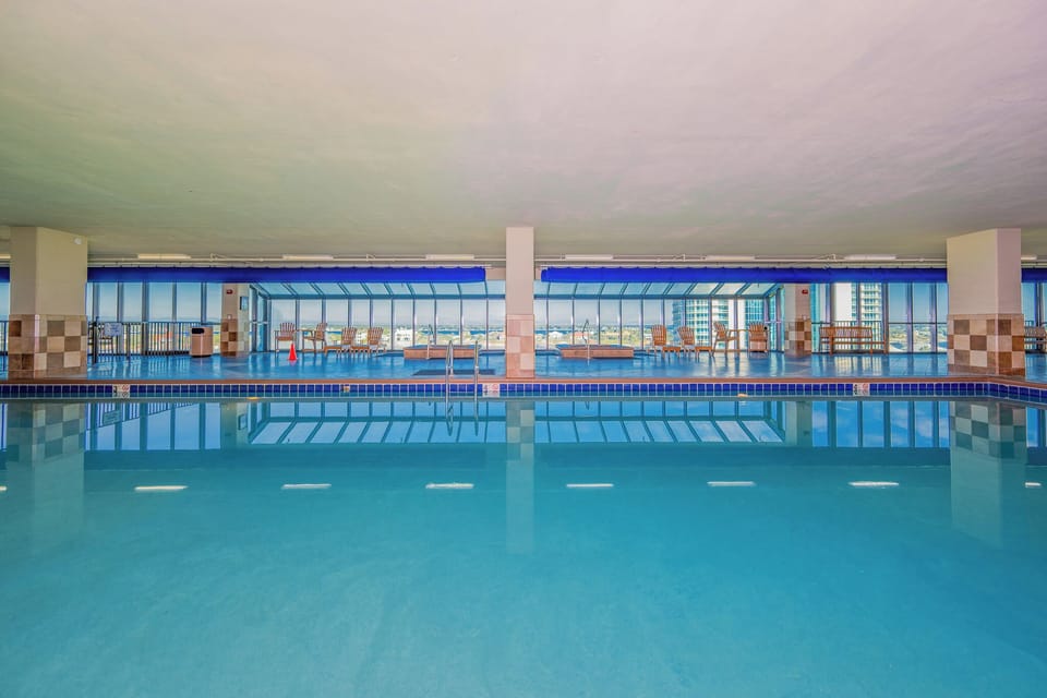 Relax in the indoor pool area with stunning views and comfortable seating for a perfect retreat to Phoenix IX in Orange Beach