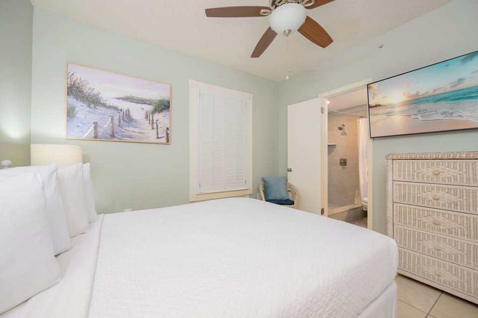 Soft bedding invites you to sink into the queen bed in the guest suite after a day of coastal adventures