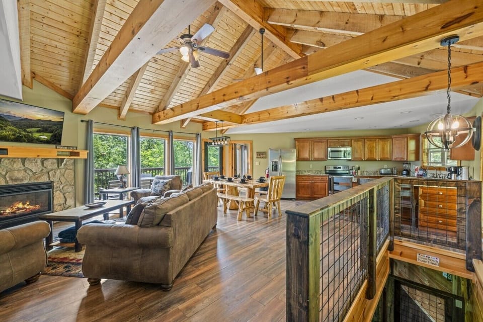 The open-concept layout connects the living room, dining area, and fully equipped kitchen, making it ideal for family gatherings and entertaining.