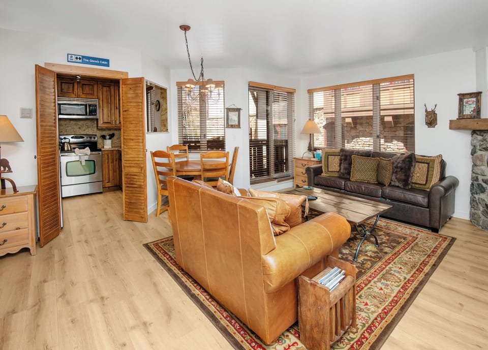 Unwind in your mountain retreat where rustic charm meets modern comfort. Leather furnishings invite relaxation while warm wood tones and natural light create a welcoming atmosphere for your alpine getaway.
