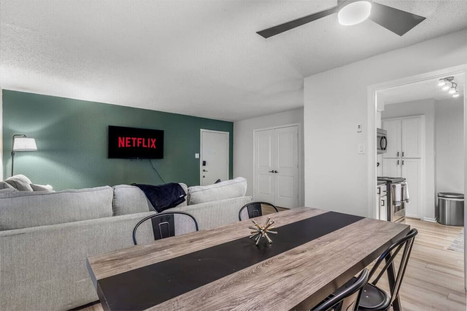 Spacious and inviting living area with comfortable seating and a smart TV, perfect for relaxing after exploring Arlington or attending events at AT&T Stadium.