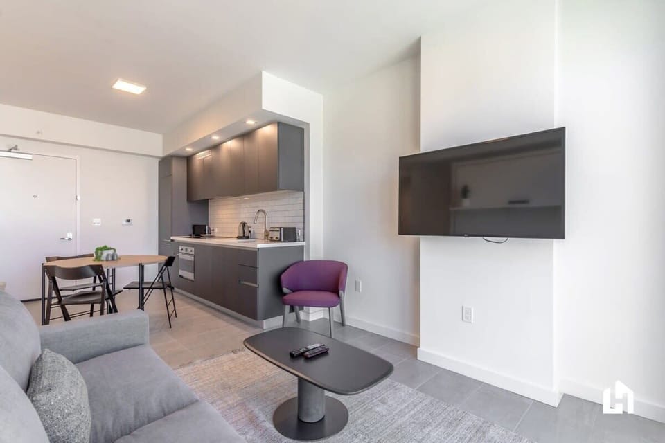 A comfortable space with a wall-mounted TV, perfect to unwind.