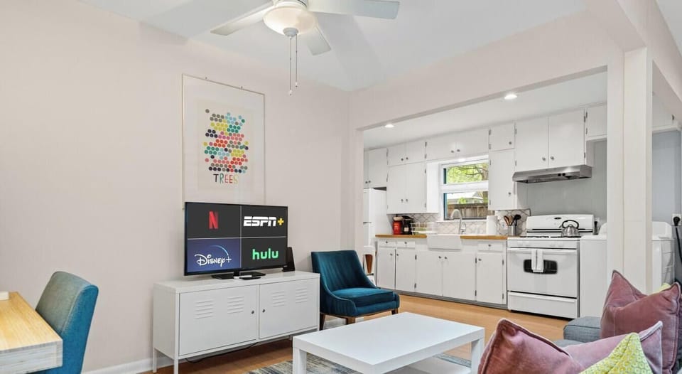 Gather in the living room with comfy seating for everyone. The open kitchen is just steps away for easy snacking.