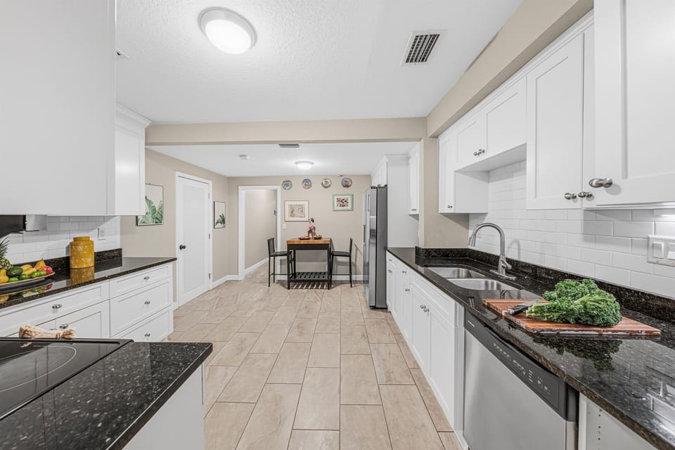 Spacious galley-style kitchen with extended countertops and easy access to dining area.