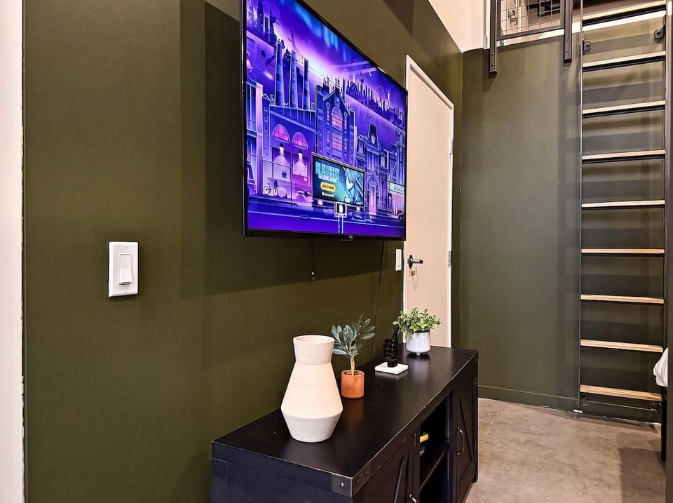 Modern loft corner with big-screen TV and sleek industrial design