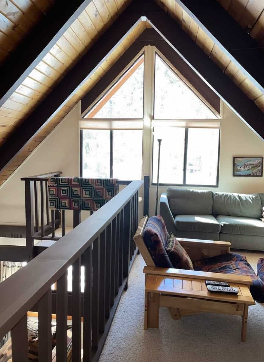 Loft sitting area with A-frame windows