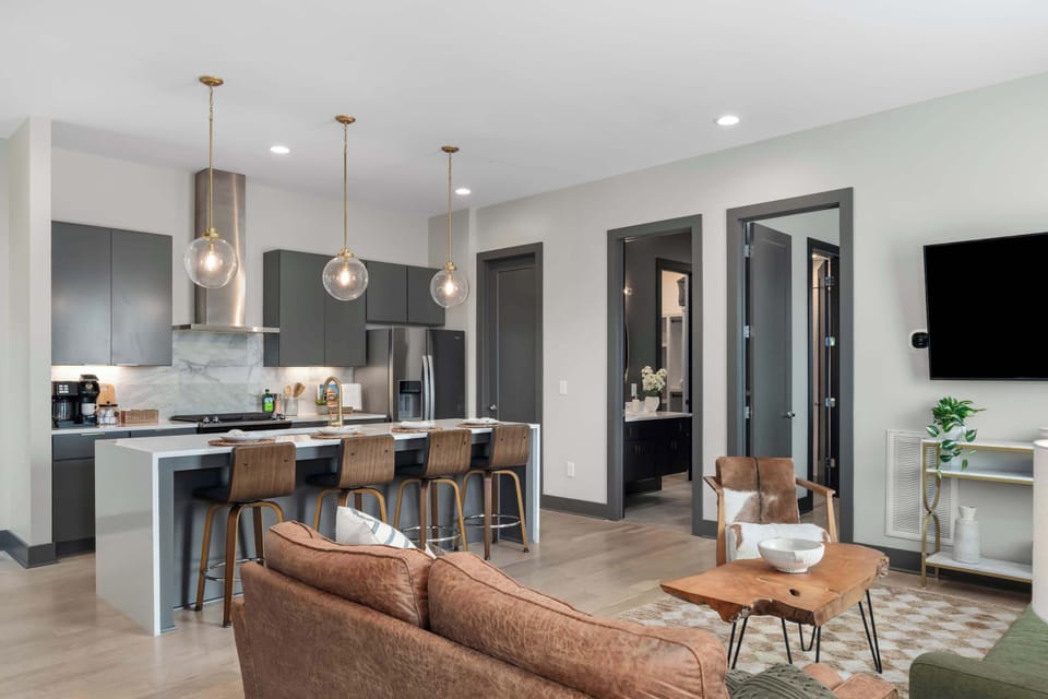 The open-plan second floor features a fully equipped kitchen island and a spacious living area. 