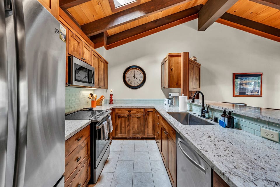 Kitchen with bar seating and stainless steel appliances