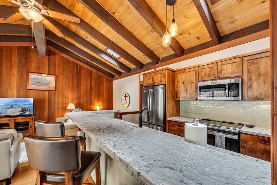 Kitchen with bar seating and stainless steel appliances