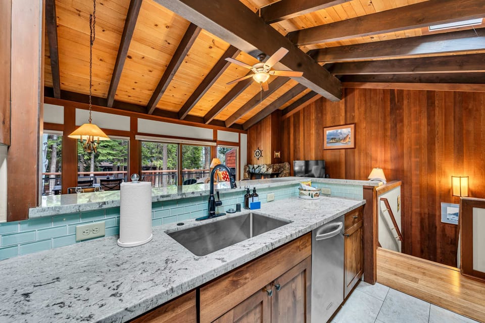 Kitchen with bar seating and stainless steel appliances
