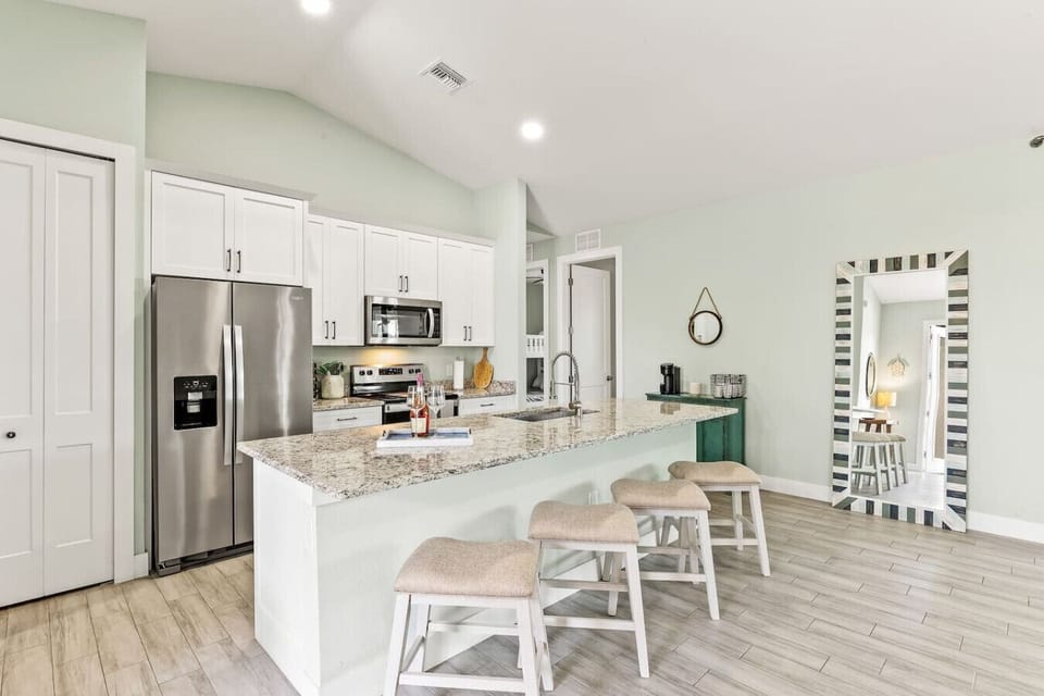 Fully equipped kitchen with breakfast bar, granite countertops, and open layout