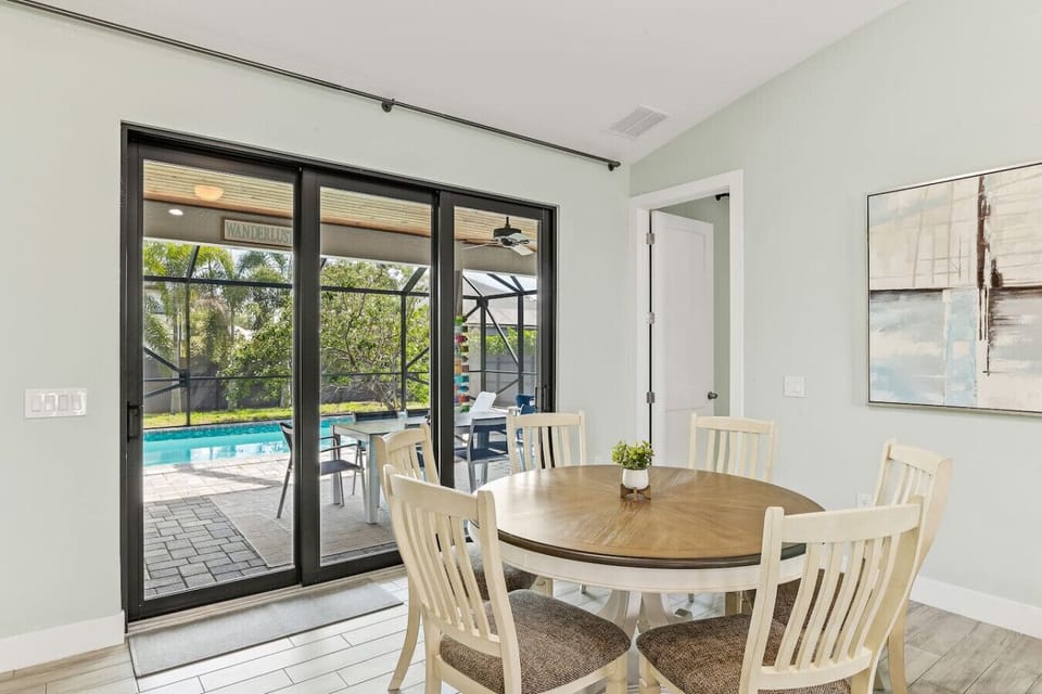 Dining space with sliding glass doors, pool views, and easy indoor-outdoor flow