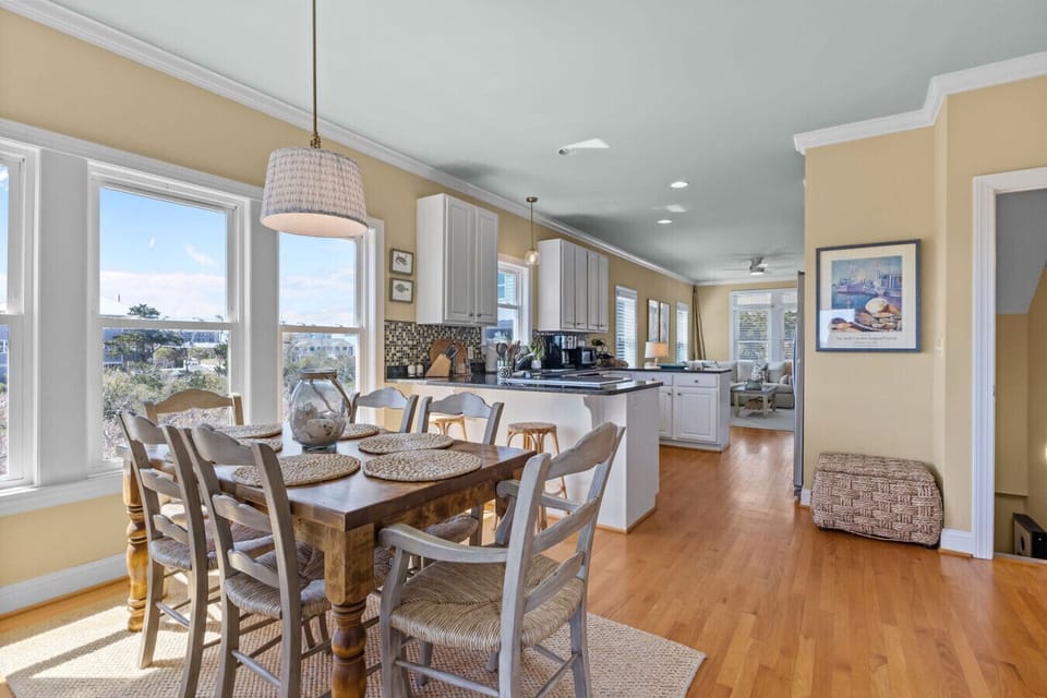 Bright open dining and kitchen area at Marsh House with natural light and coastal charm in Atlantic Beach
