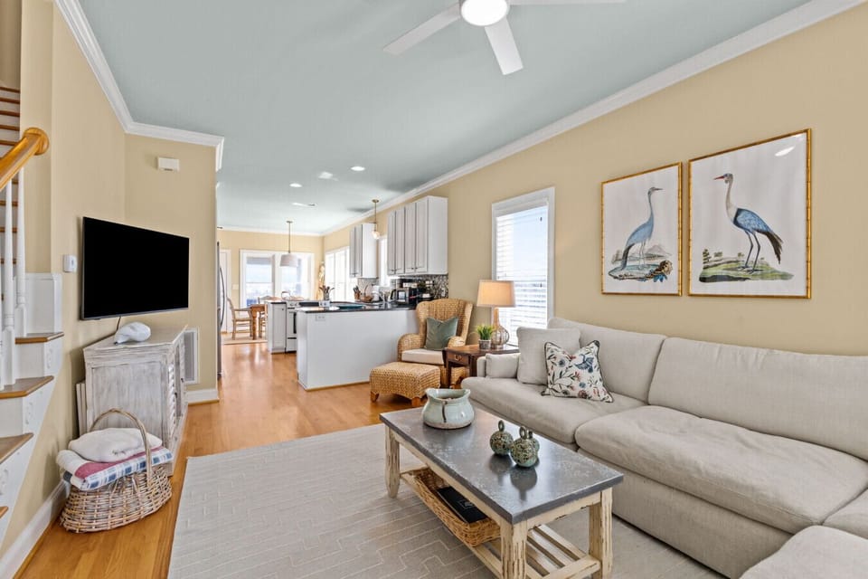 Open-concept living room and kitchen at Marsh House with cozy seating and coastal decor in Atlantic Beach