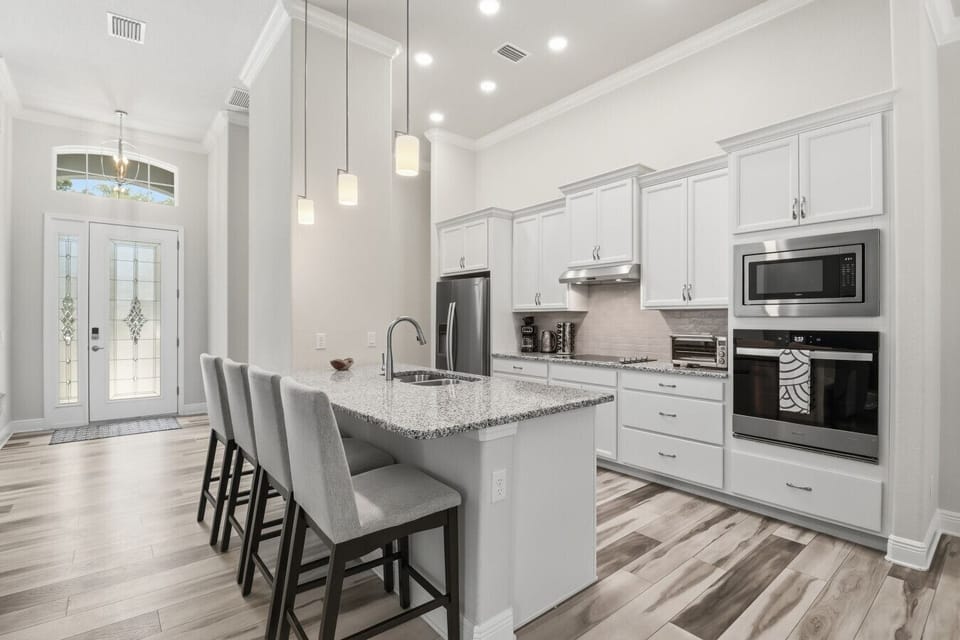 Open Kitchen | Island Seating & White Cabinetry | Pendant Lighting