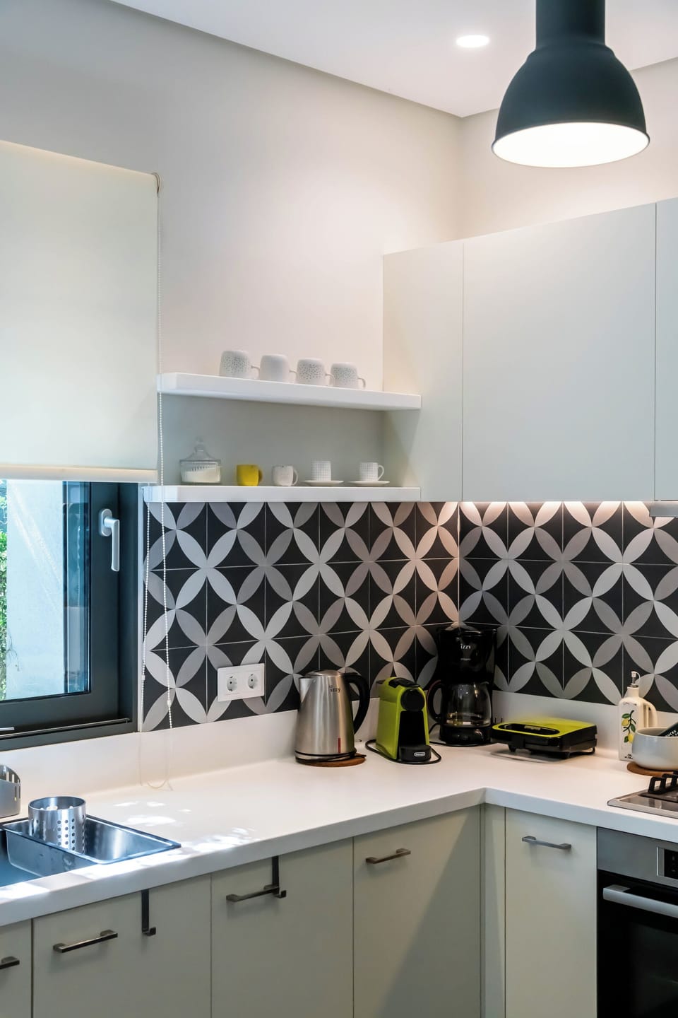 Modern kitchen with striking geometric tiled backsplash.