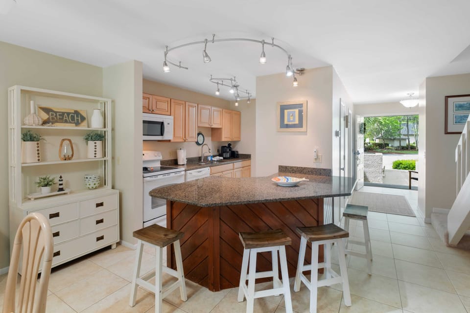 Full open airy kitchen with conversational style seating around the island
