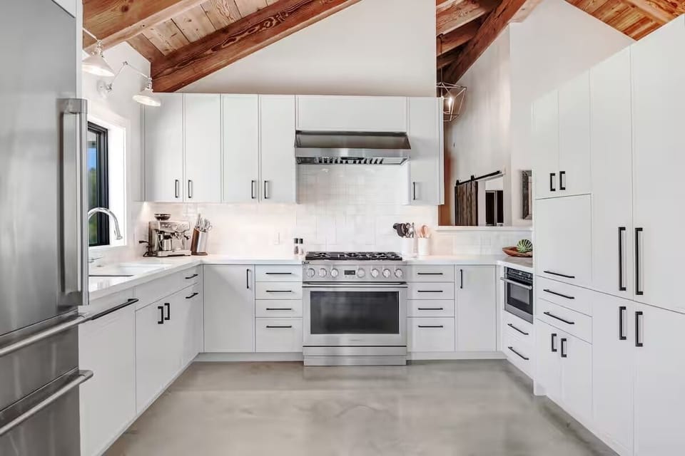 A fully stocked chef's kitchen, perfect for preparing gourmet meals with all the necessary appliances and utensils.