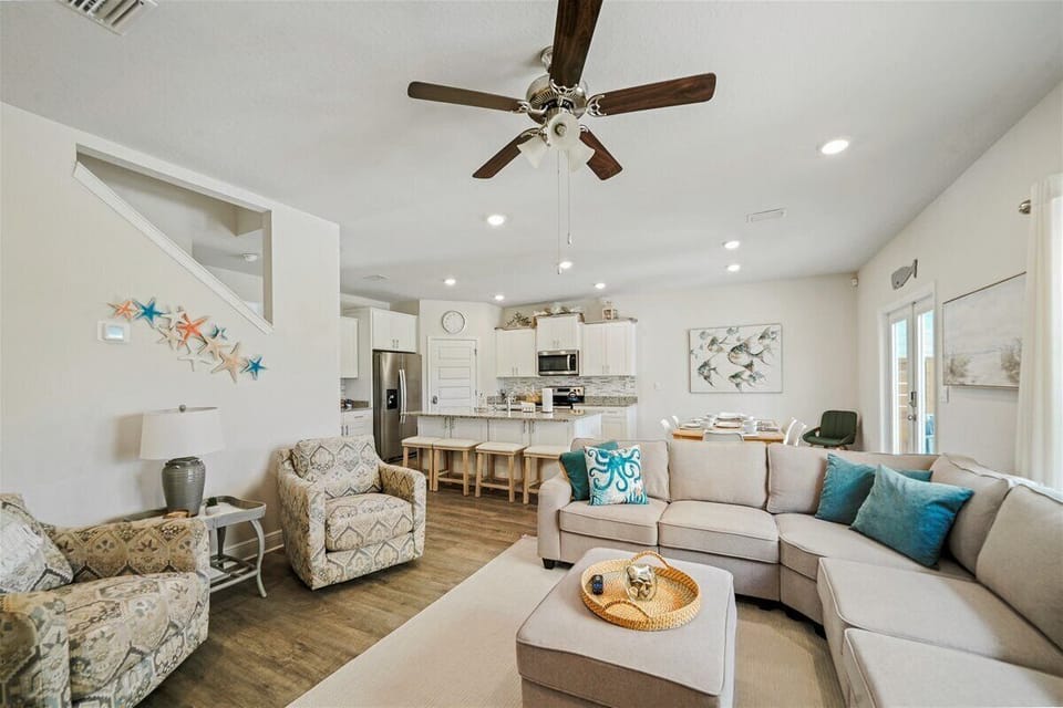Relax in comfort with cozy seating in the main living room, Smart TV, and a ceiling fan
