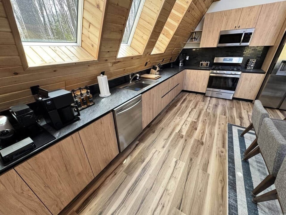 Fully modern and stocked kitchen, complete with plates, cups, mugs, wine glasses, toasters, blenders, AirFryer and much more. All the things you will need to bring home to the woods!