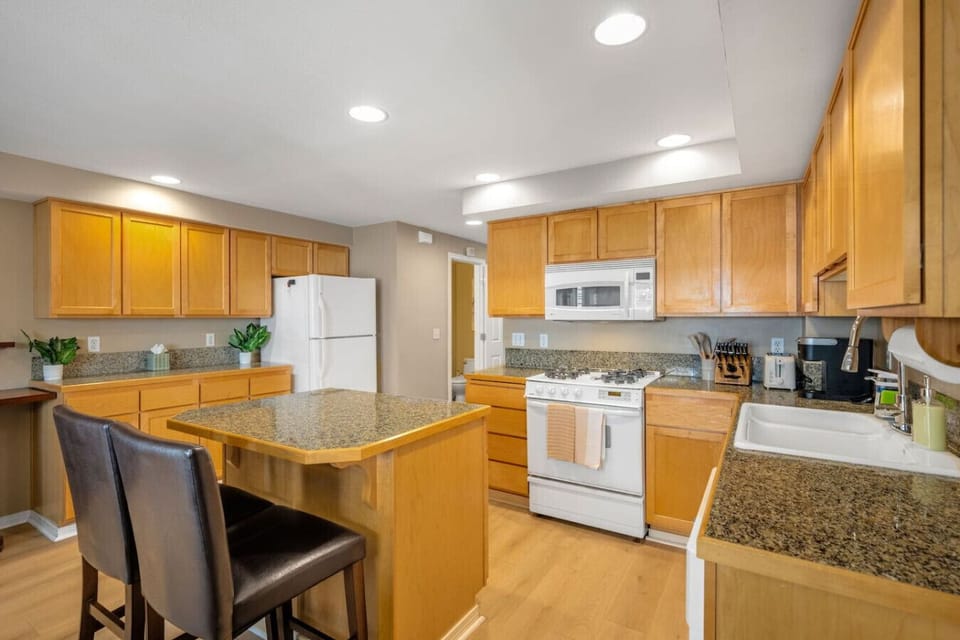 Open kitchen w/ granite counters, bar seating & everything needed for easy meals at home