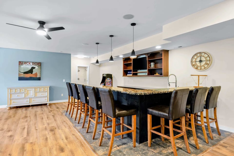 Game Room - The granite wet bar seats a crowd on leather stools, with a TV behind so nobody misses the game.