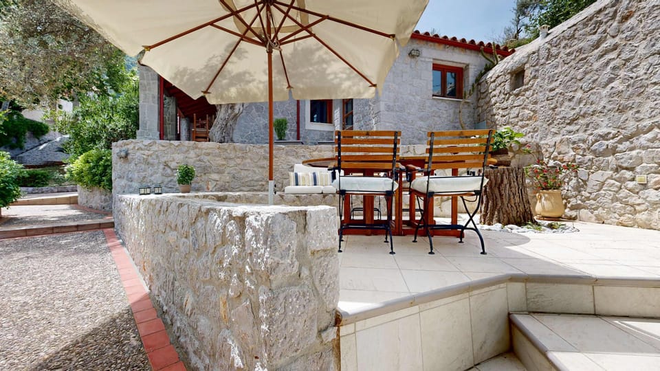 Covered Outdoor Dining Area with Garden Views