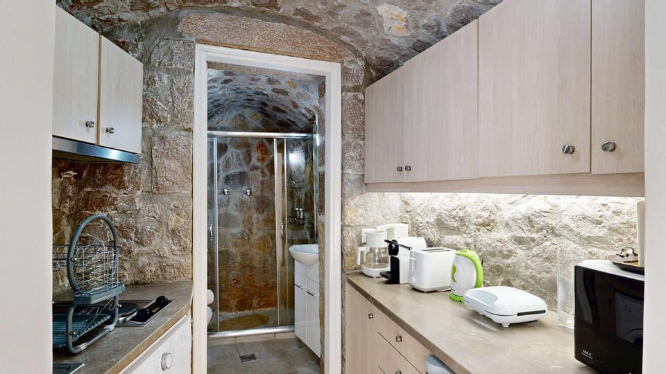 Stone Bathroom with Walk-In Shower and Rustic Charm