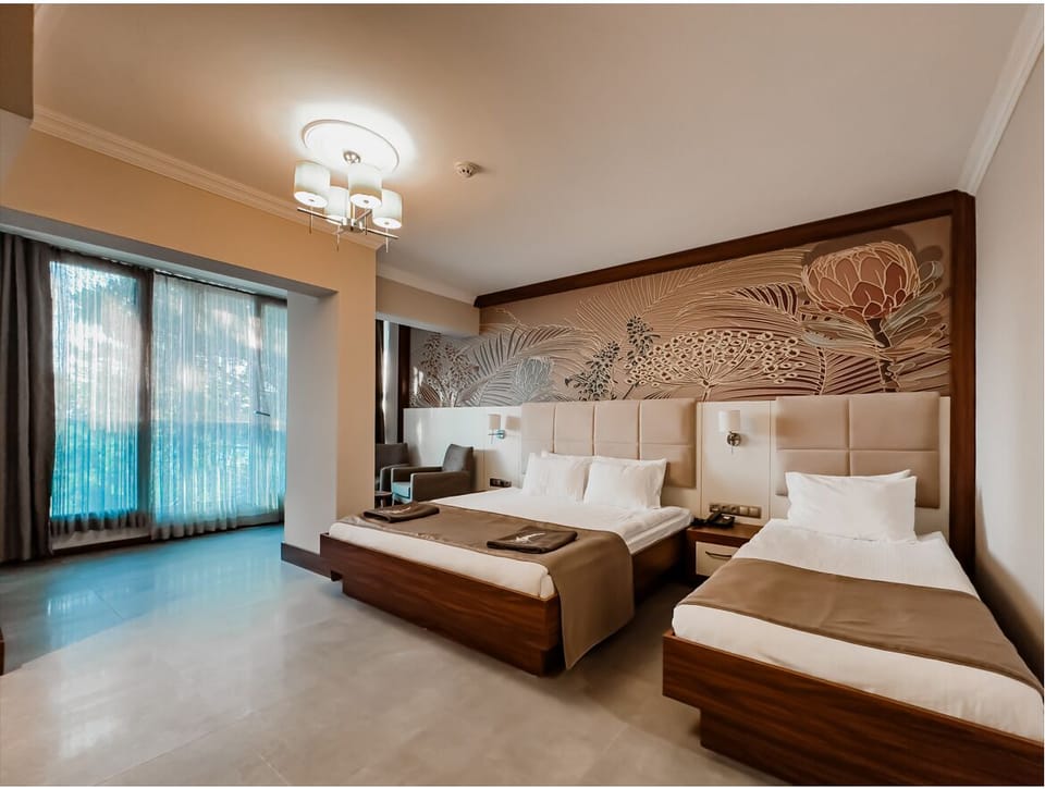 Deluxe Triple Room, Sea View | Premium bedding, minibar, in-room safe, desk
