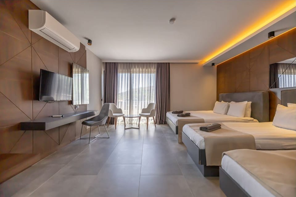 Deluxe Quadruple Room, Multiple Beds, Sea View | Premium bedding, minibar, in-room safe, desk