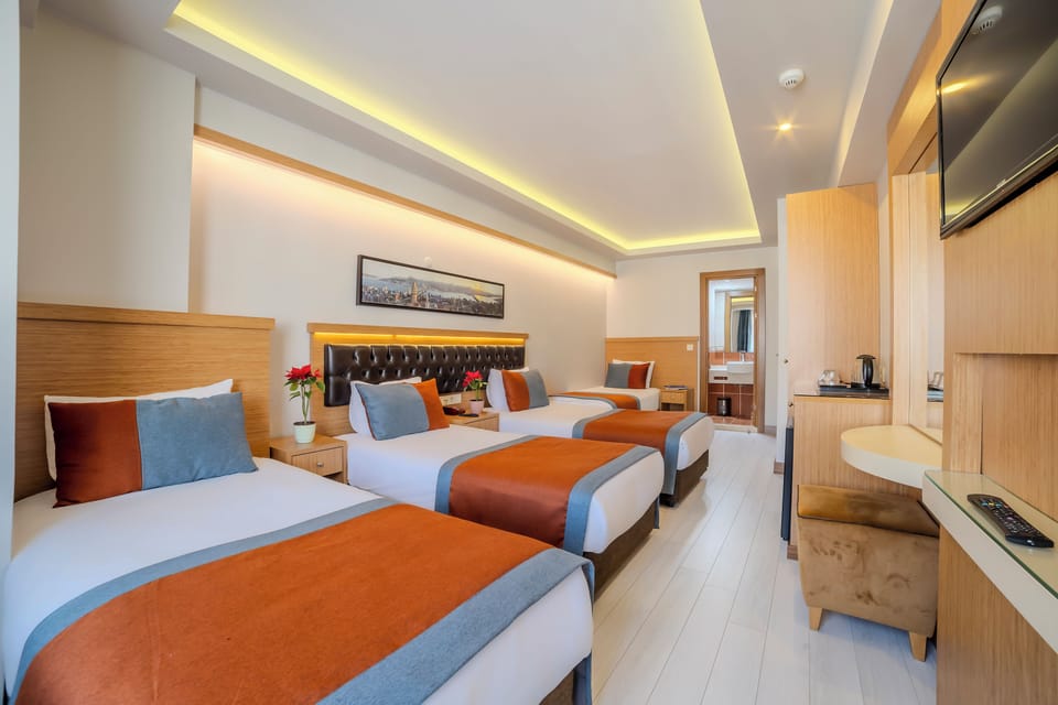 Standard Quadruple Room, City View | Premium bedding, minibar, in-room safe, desk