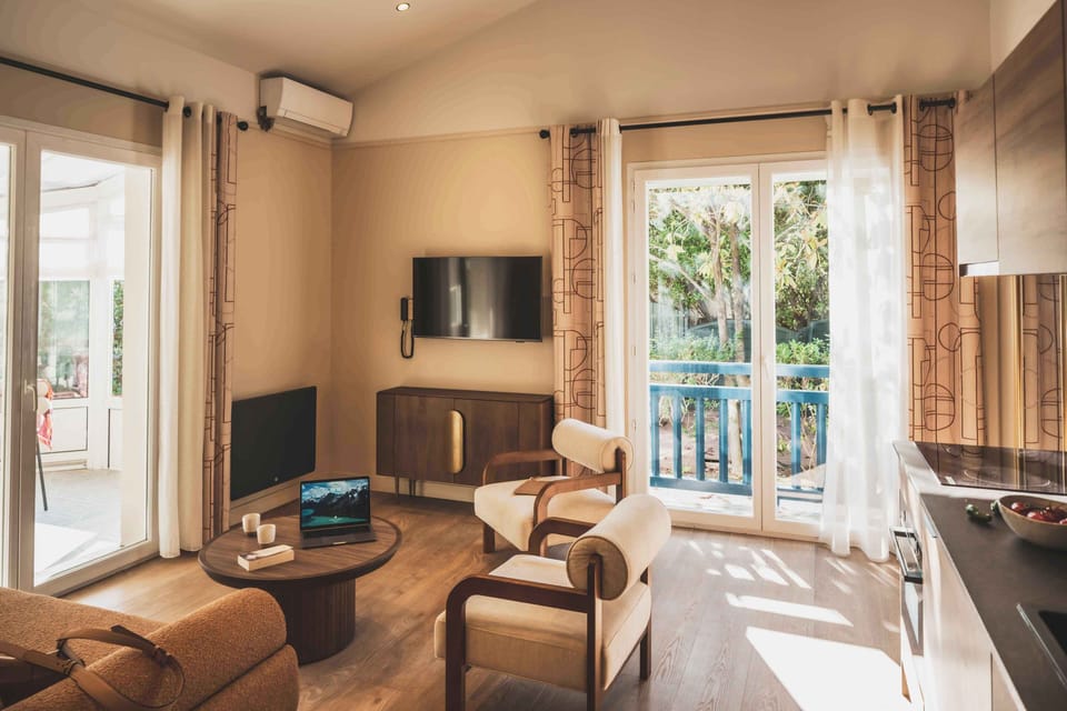 Bright living area with lounge seating, dining space, and access to the terrace — ideal for relaxed mornings or cozy evenings in Saint-Jean-de-Luz.