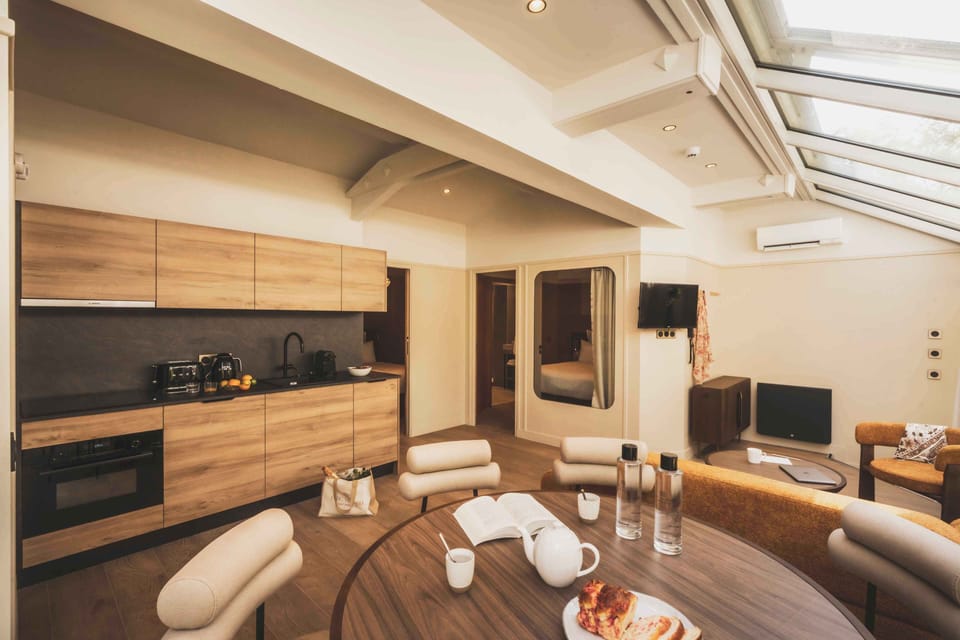 A modern open kitchen and dining area, where warm wood tones create a cozy and welcoming feel.