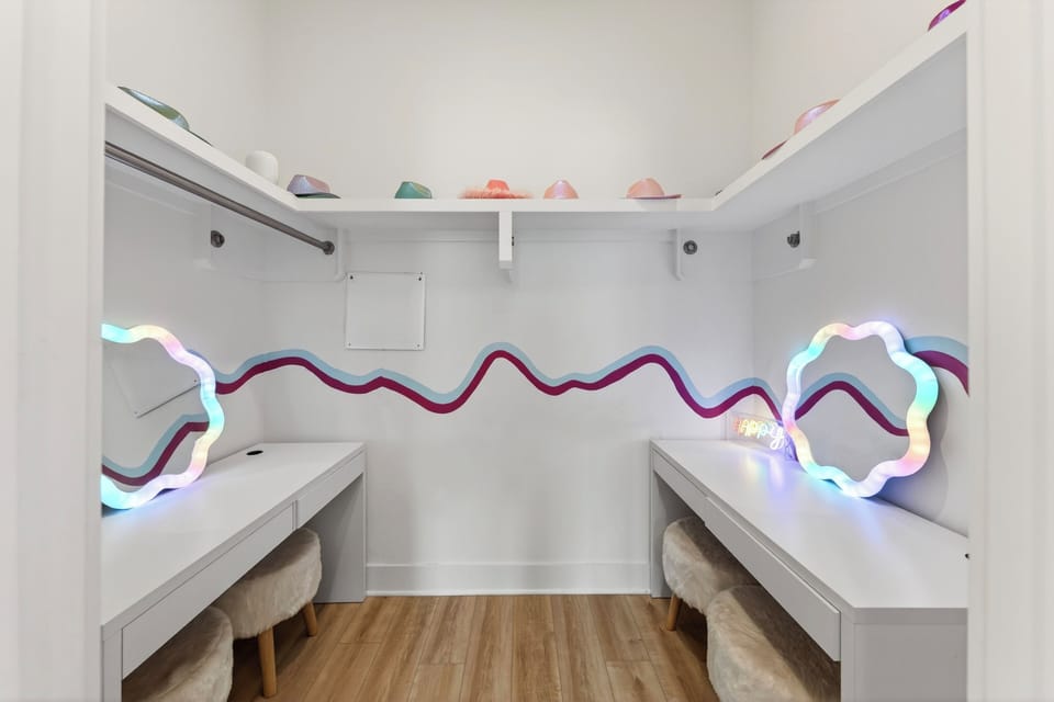 Unit 102: A fun glam station with dual vanities, playful lighting, and space to get ready for a night out.