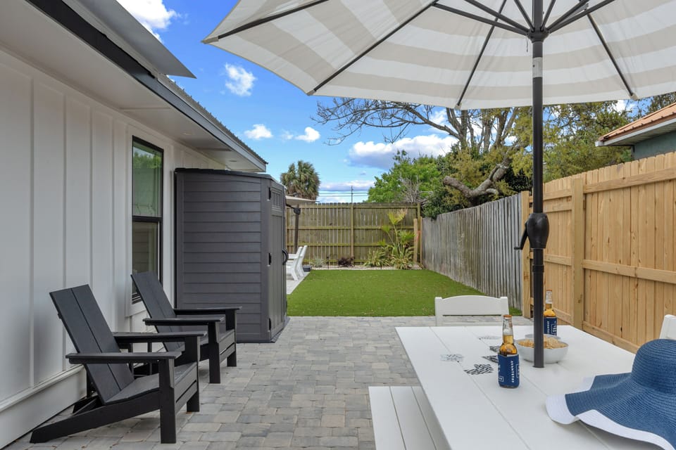 Poolside fun meets backyard comfort with organized gear, sunny skies, and a ready‑to‑relax vibe.