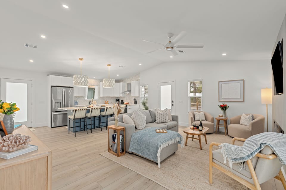 Open‑concept living space blending a bright kitchen and a cozy lounge for effortless everyday comfort.