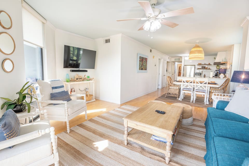 “Coastal‑calm living room with soft blues, woven textures, and a bright, breezy vibe.